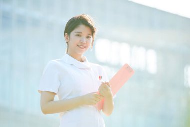 Açık havada gülümseyen Asyalı (Japon) kadın hemşire portresi