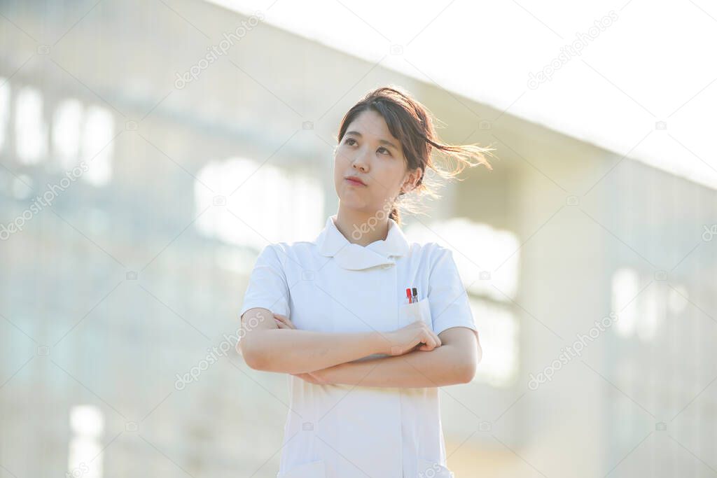 Asian (Japanese) female nurse who tilts her face and feels doubts