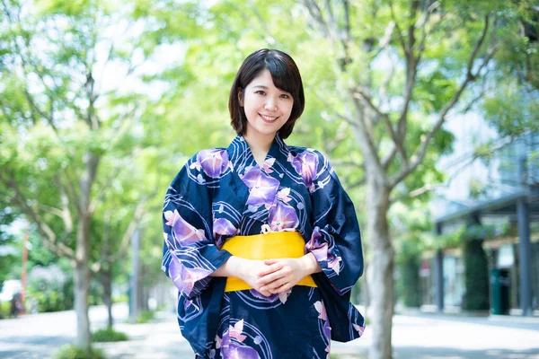 Asian (Japanese) woman going to town wearing a yukata (Japanese traditional costume)