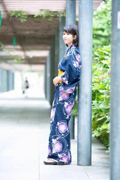 Asian (Japanese) woman going to town wearing a yukata (Japanese traditional costume)