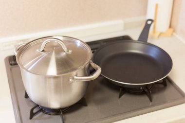 Mutfak gaz ocağına konmuş tencere ve tava gibi mutfak aletleri