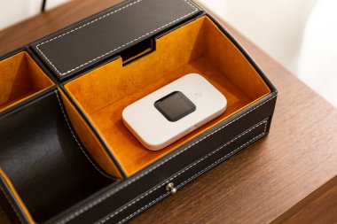 Küçük, taşınabilir bir kablosuz bağlantı cihazı bir evin içine yerleştirilmiş.