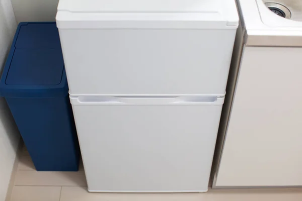 White refrigerator installed in the kitchen of the living space