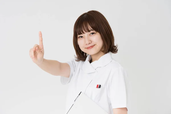 アジア人 日本人 女性看護師の人差し指でポーズ — ストック写真