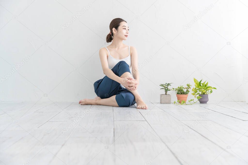 Asian young woman doing mild exercise in a bright room