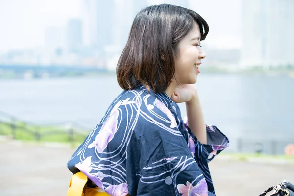 Asian (Japanese) woman going to town wearing a yukata (Japanese traditional costume)