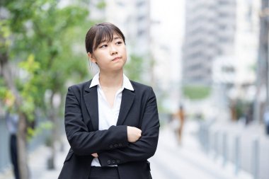 Asyalı (Japon) genç bir bayan çalışanın sıkıntılı bir ifadesi var.
