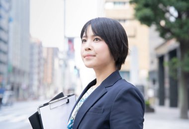 İş bölgesinde genç Asyalı (Japon) iş kadınının portresi