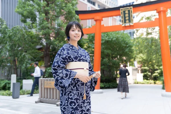 Asian (Japanese) woman going to town wearing a yukata (Japanese traditional costume)