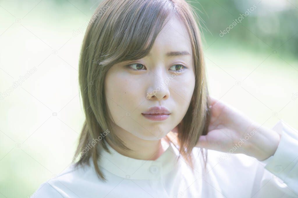 Asian young woman walking in the park with a relaxed look