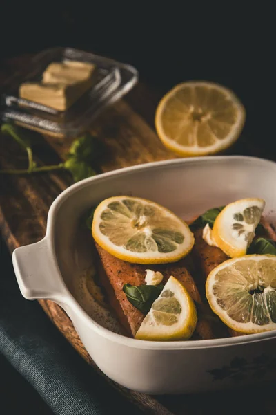 Two Pieces Raw Salmon Covered Butter Basil Lemon Slices Casserole — Stock Photo, Image