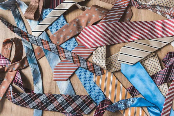 Messy Pile Colored Patterned Ties Wooden Background Top View — Stock Photo, Image