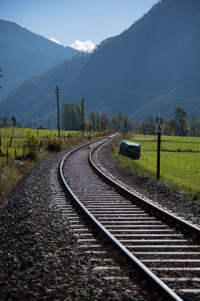 Railroad tracks in the background the mountains, Bavarian landscape Royalty Free Stock Photos