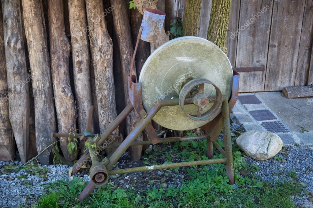 Old grinding wheel in front of barn — Stock Photo © munich1 127322016