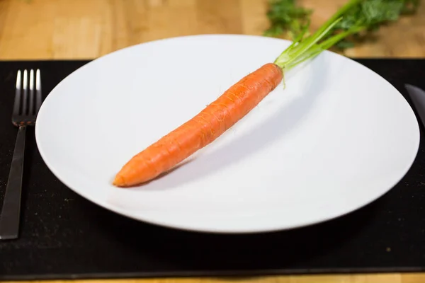 Carrot on plate, diet, white plate