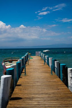 Shore Bardolino, mavi gökyüzü üzerinde ahşap yürüme yolu