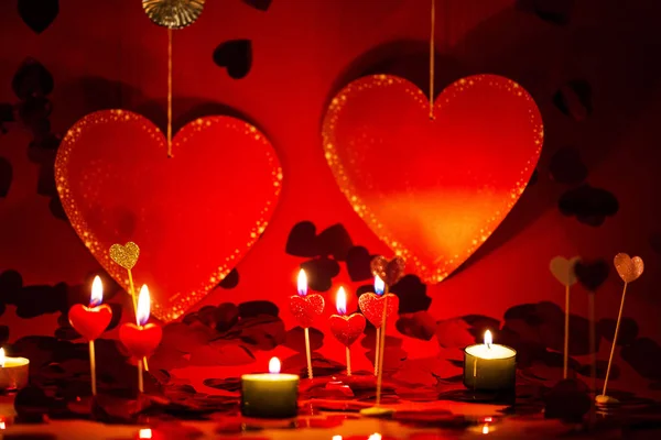 Hearts and candles, red background, romantic