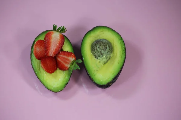Avocado gehalveerde, gevuld met aardbeien — Stockfoto