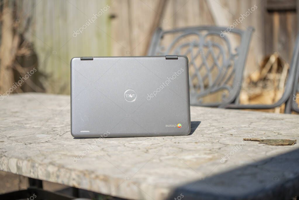 Elgin, Illinois - Circa 2019: A Chromebook sitting on a table outside. This Wireless device can be used from anywhere.