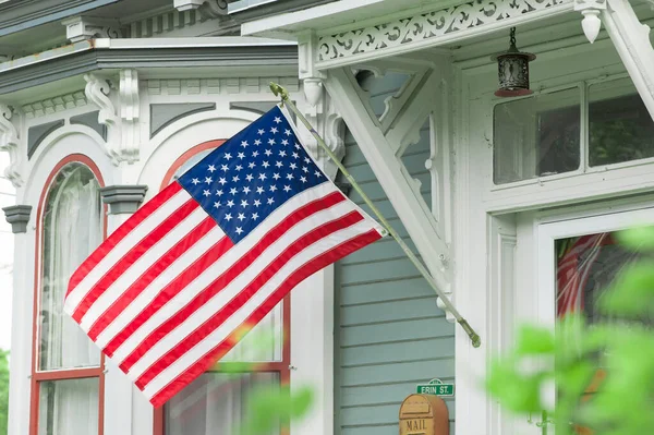 An American home proudly displaying thier flag.