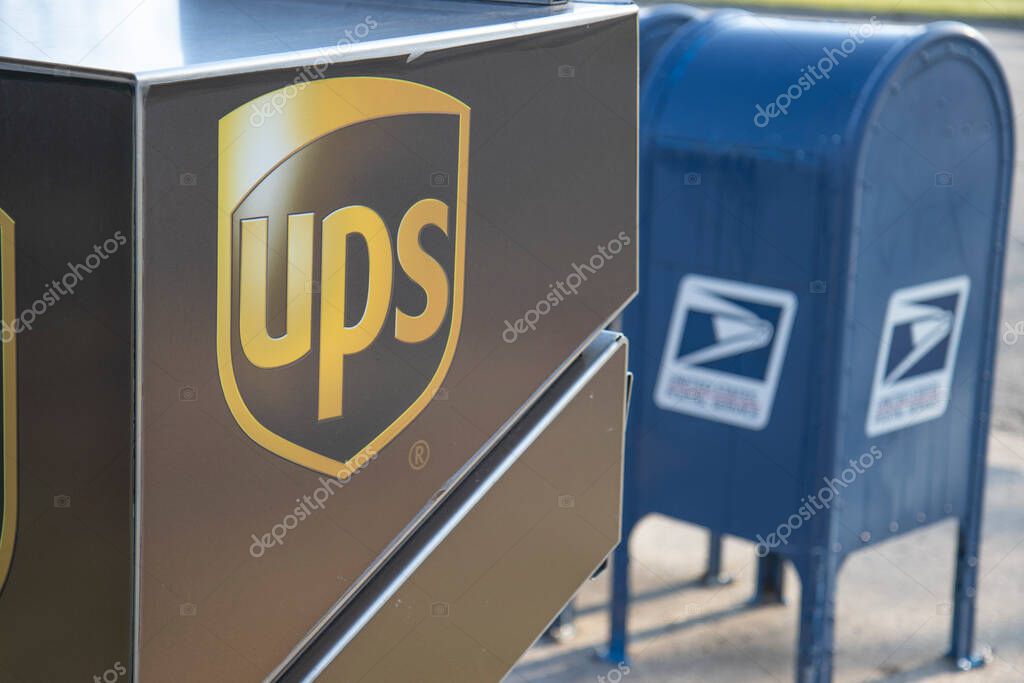 Chicago Illinois, USA - Circa 2020: An abstract representation of government versus privately owned companies.A USPS and UPS drop off location shown in a manor to reflect their fierce competition and rivalry.