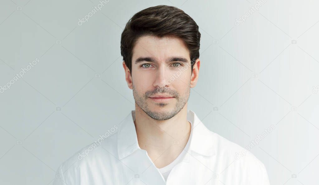 Portrait of handsome doctor or scientist wearing a white coat looking at camera, isolated on white background. 