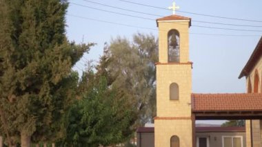 Batan güneşin altında eski bir kilise. Kuşlar çan kulesinin etrafında uçar.