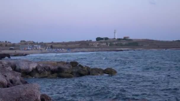 Rocky Shore Sea Washed Light Waves Sunset Time Lighthouse Hill — Stock Video