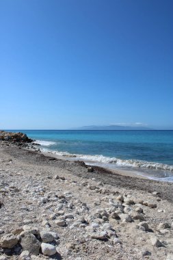 Güneşli bir günde taşlı güzel bir sahil manzarası.