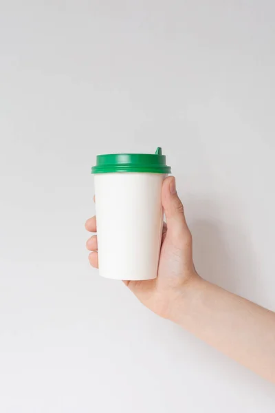 Take away coffee cup background. Male hand holding a coffee paper cup