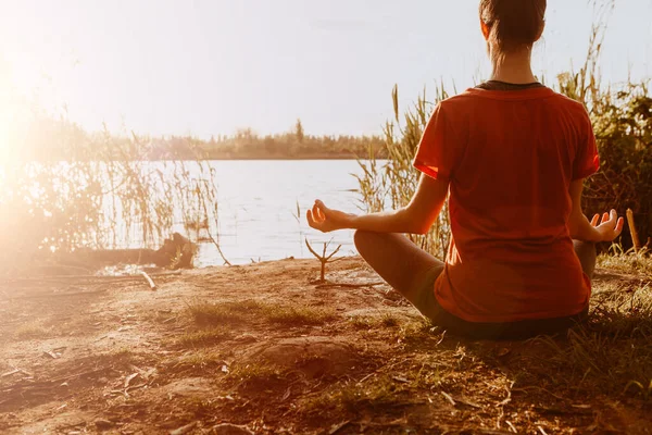 Yoga in the park, health woman. Concept of healthy lifestyle and relaxation