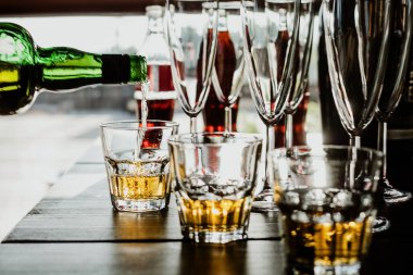 Viski şişeden bardağa doluyor. Festivalde resepsiyon. Barmenin işi.