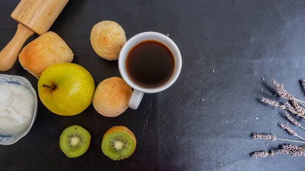 Black coffee and bakery in black background. Healthy breakfast in beautiful set up. coffee lover,