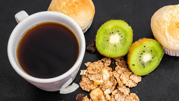 Black coffee and bakery in black background. Healthy breakfast in beautiful set up with lavender fruits. coffee lover,