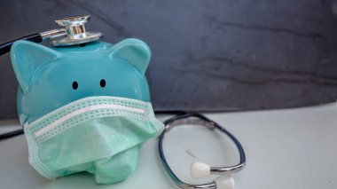 Stetoskop ve Domuz Kumbarası Koruyucu Tıbbi Yüz Maskesi takıyor, beyaz arka planda izole edilmiş..