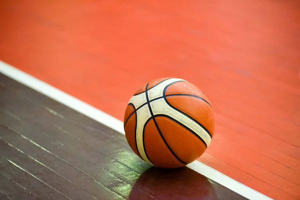 Basketball ball on the parquet floor