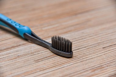 Ahşap masada tek bir yumuşak diş fırçası.