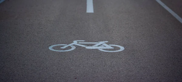 detail of a traffic sign of a bicycle painted in white on the asphalt in a bicycle lane