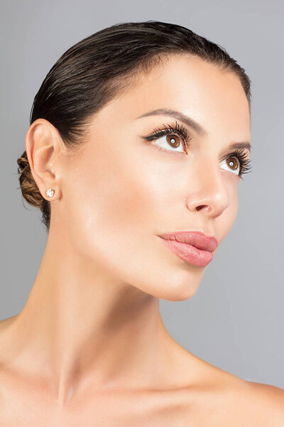 Portrait of young beautiful young woman on white background.