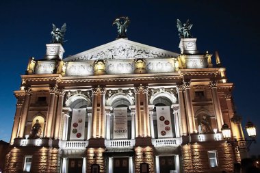 Gece gökyüzüne karşı bir opera binası.