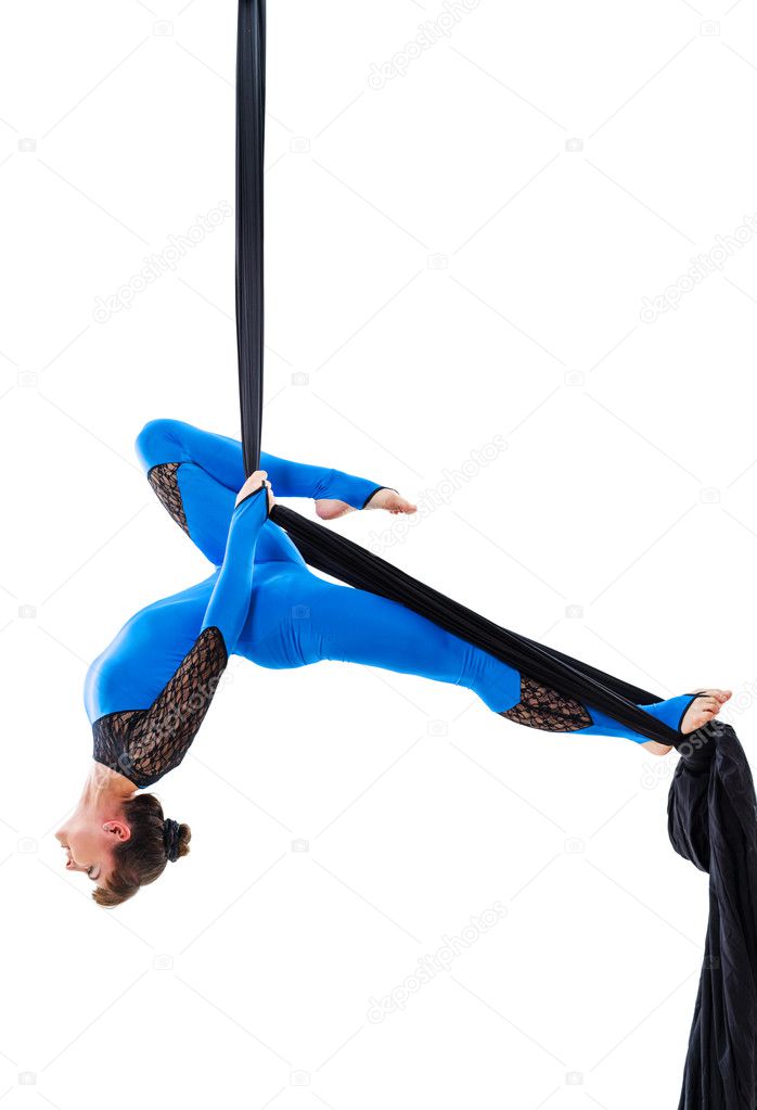 Woman hanging in aerial silk, isolated on white