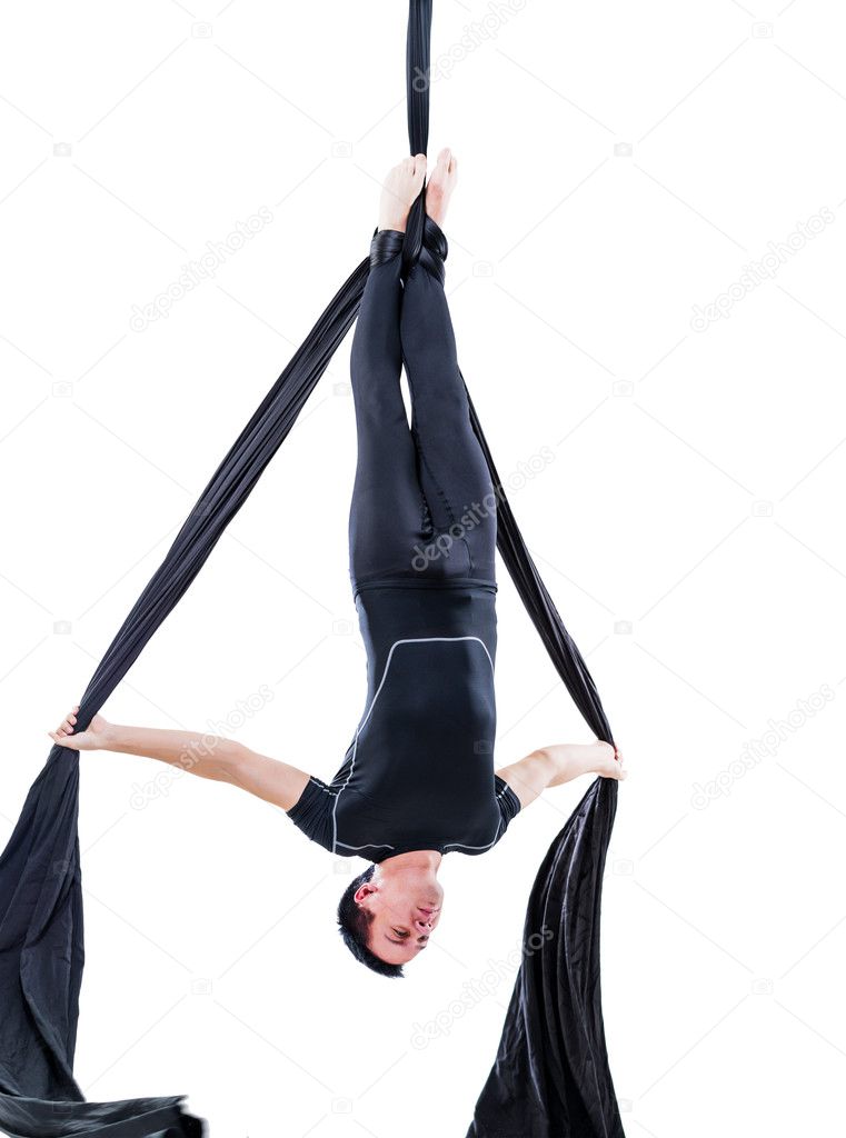 man hanging in aerial silk, isolated on white
