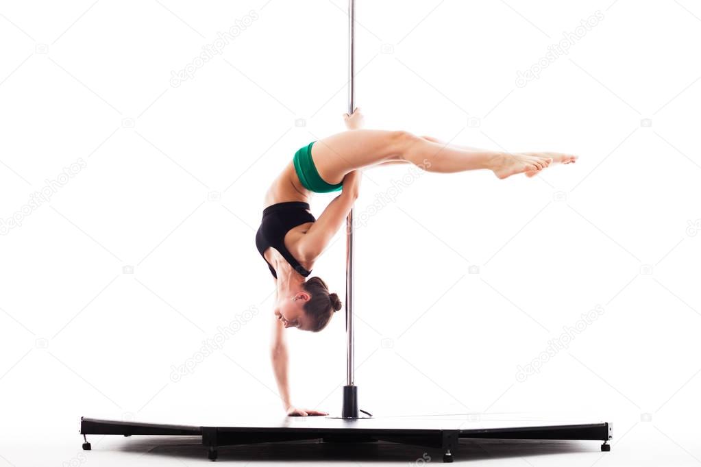 Woman doing pole dance, isolated on white