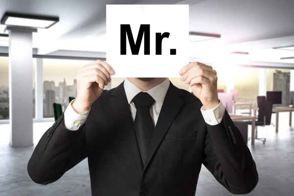 Businessman hiding face behind sign mister — Stock Photo, Image