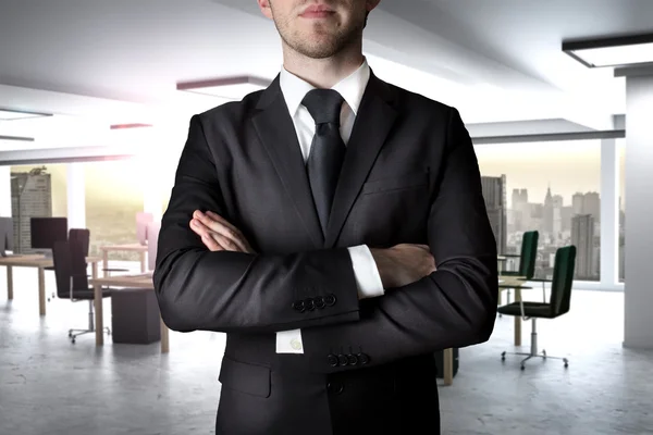 Businessman crossed arms in modern office — Stock Photo, Image