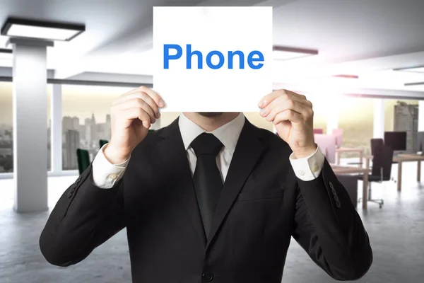 Businessman hiding face behind sign phone — Stock Photo, Image