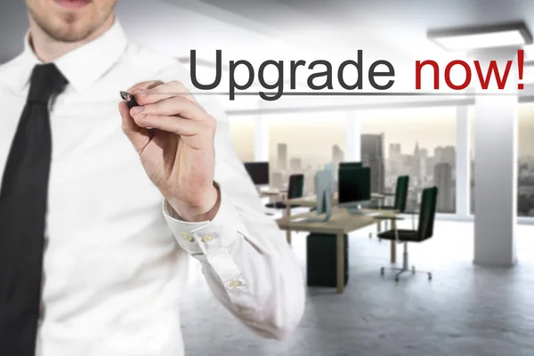 Businessman writing upgrade now in the air — Stock Photo, Image