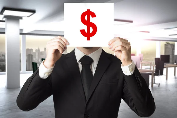 Бизнесмен прячет лицо за знаком доллара — стоковое фото