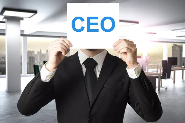 Businessman hiding face behind sign ceo — Stock Photo, Image