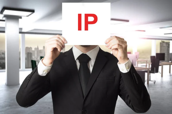 Businessman hiding face behind sign ip — Stock Photo, Image